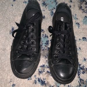 Black leather converse shoes.